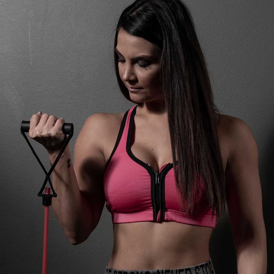 Female athlete performing bicep workout with power tubes