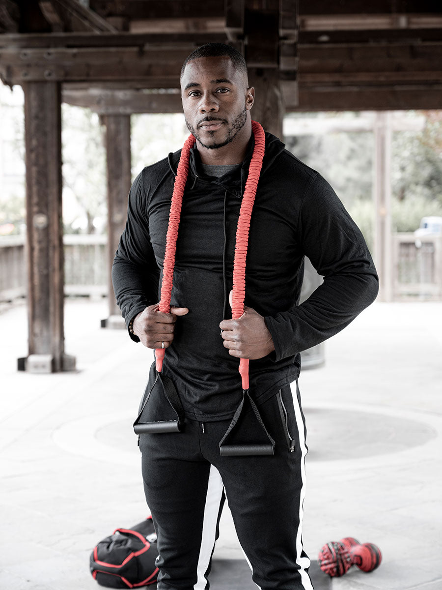 Fitness athlete with advanced toner draped over his shoulders